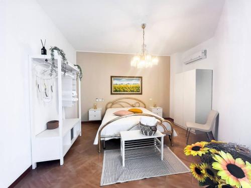 a bedroom with a large bed and a table at CasaLina Perfect House in Altamura
