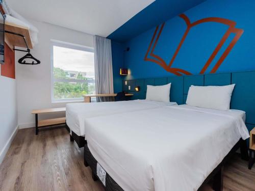 Una cama o camas en una habitación de ibis Styles Poços de Caldas