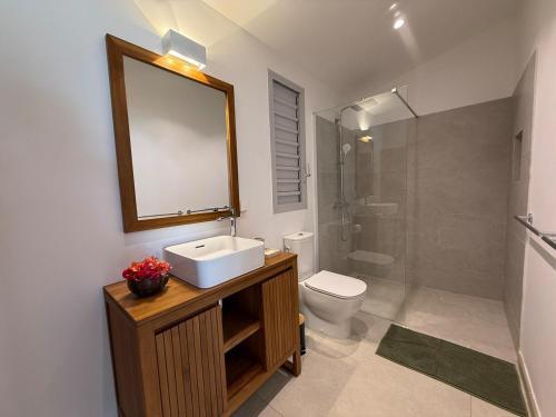 a bathroom with a sink and a toilet and a mirror at EAST KEYS - Villa Jamming, piscine à débordement et accès privé à la mer in Le Vauclin