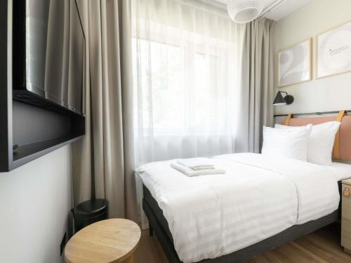 a hotel room with a bed and a window at Oru Hub Hotel Tallinn - Handwritten Collection in Tallinn