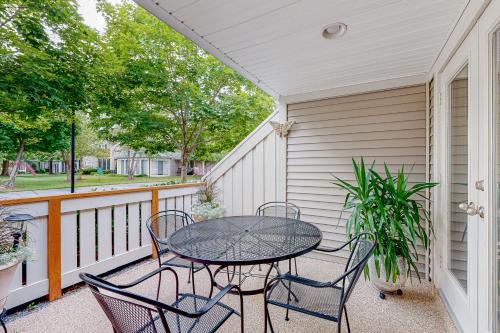 a patio with a table and chairs on a balcony at Sea Colony - 56216 Pine Branch Way in Bethany Beach