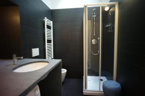 a bathroom with a shower and a sink and a toilet at Prione 132 in La Spezia