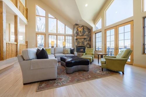 a living room with couches and chairs and a fireplace at Vail View by AvantStay Minutes from Beaver Creek in Dowds Junction