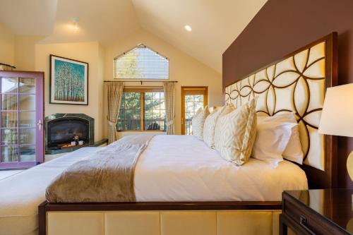 a bedroom with a large bed and a fireplace at Vail View by AvantStay Minutes from Beaver Creek in Dowds Junction