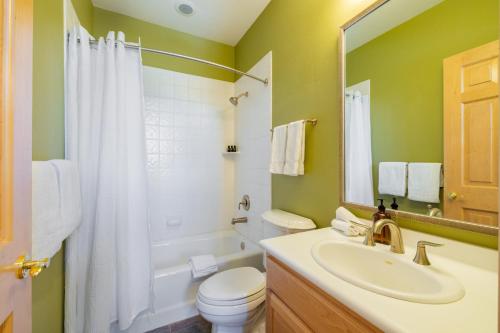 a bathroom with a sink and a toilet and a mirror at Vail View by AvantStay Minutes from Beaver Creek in Dowds Junction