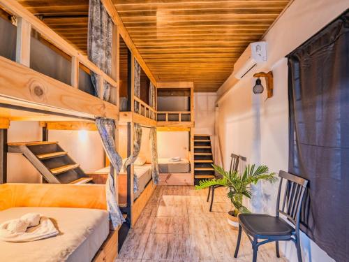 a small room with bunk beds and a staircase at Koru Boutique Hostel Uvita in Uvita