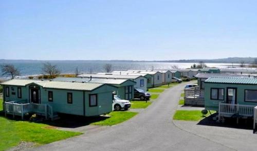 a row of mobile homes parked in a parking lot at Loch View 28 in Stranraer