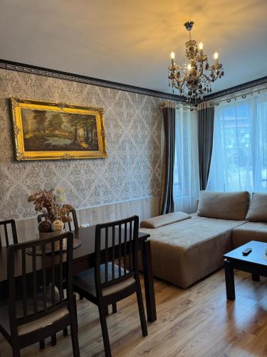 a living room with a couch and a table at Pirin Elegance Apartment by Gondola Lift in Bansko
