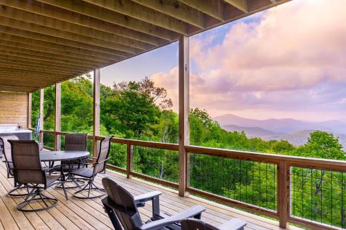 a screened in porch with a table and chairs at Above and Beyond in Boone