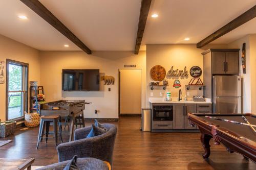 a kitchen and living room with a pool table at Above and Beyond in Boone