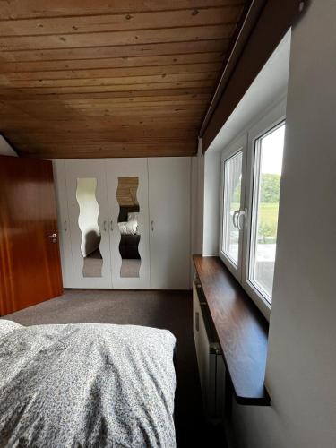 a bedroom with a bed and a desk and a window at Holiday Nest in Sønderborg