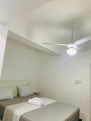 a bedroom with two beds and a ceiling fan at Plataview Apartahotel 3B in Monte Plata
