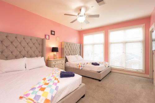 a bedroom with two beds and a ceiling fan at Pink Experience - West End Broadway & Restaurants in Nashville