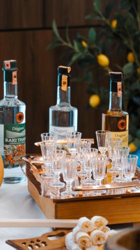 two bottles of alcohol sitting on a tray with glasses at Grand VM Conference & SPA in Golem