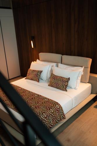 a large bed with four pillows on a ship at Grand VM Conference & SPA in Golem