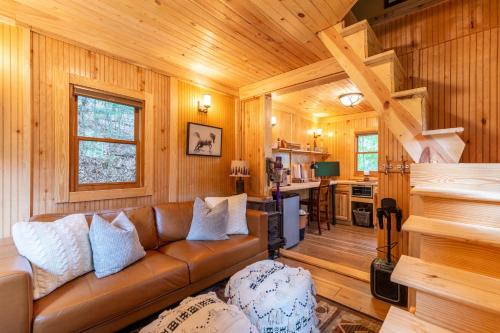 a living room with a couch and a kitchen at Moonlight Lodge in Fleetwood