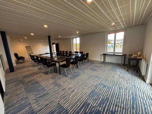 a conference room with a table and chairs in it at ibis Styles Morlaix in Morlaix