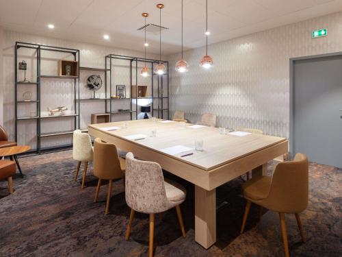 a conference room with a large table and chairs at Mercure Aix-les-Bains Domaine de Marlioz Hôtel & Spa in Aix-les-Bains
