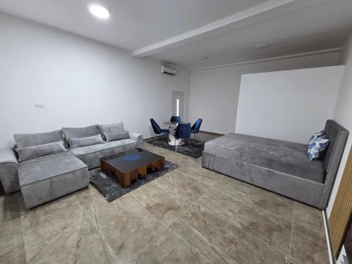 a living room with a couch and a table at Relax 2 in Bukorovac