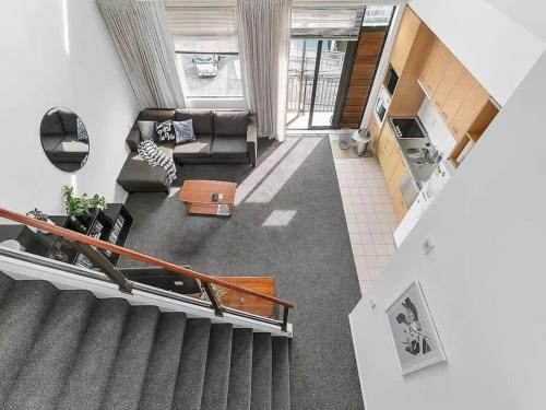 an overhead view of a living room with a staircase at Roomy Loft 2 Bedroom with Free Parking Zodiak Stays in Auckland