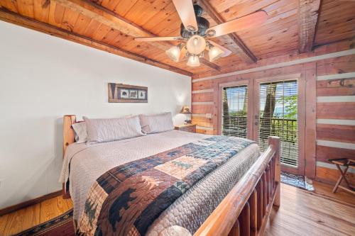 a bedroom with a bed and a ceiling fan at Mountain Masterpeace in Banner Elk