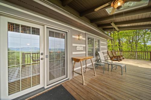 a screened in porch with a table and chairs on it at Mountain Masterpeace in Banner Elk