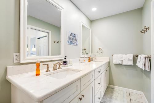 a white bathroom with two sinks and a mirror at Sea Colony - 53021 Lakeshore Dr in Wilgus Subdivision