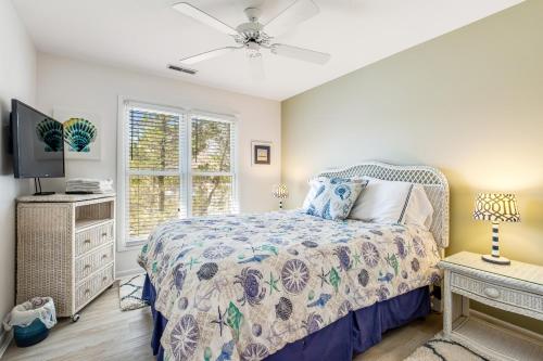 a bedroom with a bed and a tv and a window at Sea Colony - 53021 Lakeshore Dr in Wilgus Subdivision