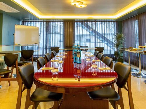 a conference room with a large table and chairs at MUZE Hotel Dusseldorf - Handwritten Collection in Düsseldorf