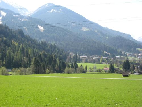 a field of green grass with a mountain in the background at Landhaus Thurner in Wagrain