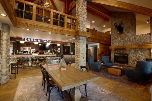 a restaurant with a table and chairs and a bar at Gravity Haus Big Sky in Big Sky