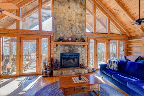 a living room with a blue couch and a fireplace at Fox's Lair in Sugar Grove