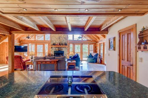 a kitchen and living room with wood ceilings and a stove at Fox's Lair in Sugar Grove