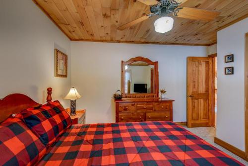 a bedroom with a bed and a dresser and a mirror at Fox's Lair in Sugar Grove