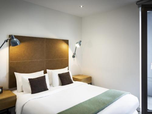Ένα ή περισσότερα κρεβάτια σε δωμάτιο στο Aparthotel Adagio London Brentford