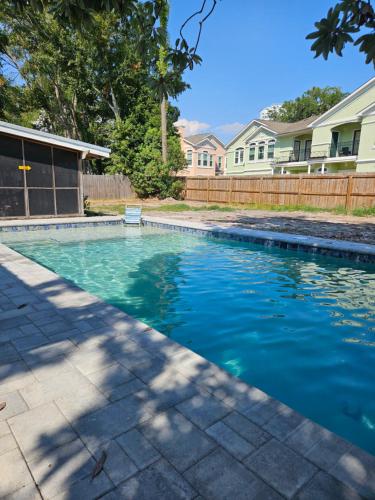 a swimming pool with blue water in a yard at Gulf Breezes in Gulfport