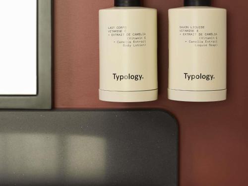 a couple of bottles of lip gloss on a counter at Le Talaia Hôtel & Spa Biarritz - MGallery Collection in Biarritz