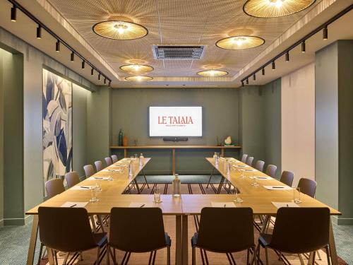 a conference room with a long table and chairs at Le Talaia Hôtel & Spa Biarritz - MGallery Collection in Biarritz