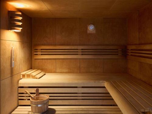 a sauna with two bunk beds and a bucket at Le Talaia Hôtel & Spa Biarritz - MGallery Collection in Biarritz