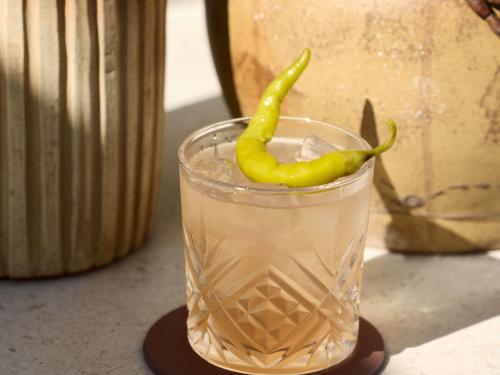 a drink with a green pepper in a glass at Le Talaia Hôtel & Spa Biarritz - MGallery Collection in Biarritz