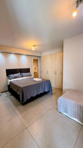 a bedroom with a large bed and a bedskirts at Unidade Autonoma 609 em Villa Del Sol in Rio de Janeiro