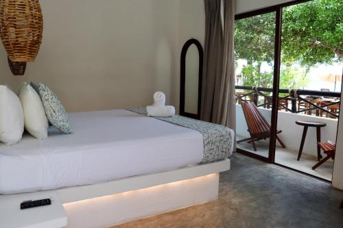 Cama o camas de una habitación en HAU Holbox, Oceanfront Boutique Hotel