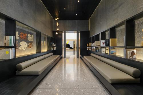 a room with a long line of benches in a building at Be Grand by Wynwood House in Mexico City