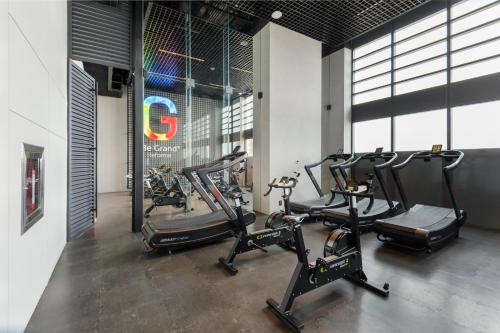 a gym with several cardio machines in a room at Be Grand by Wynwood House in Mexico City