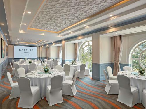 a conference room with white tables and white chairs at Mercure Nha Trang Beach in Nha Trang
