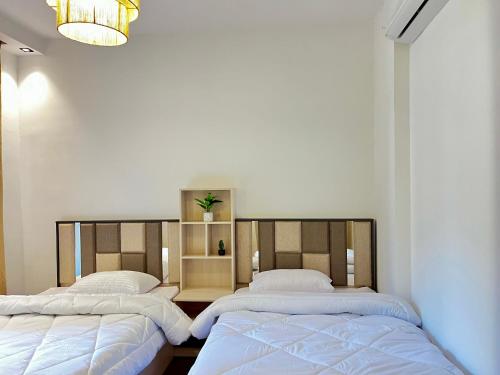 two beds sitting next to each other in a room at Snow light 2BDR , Madinaty in Madinaty