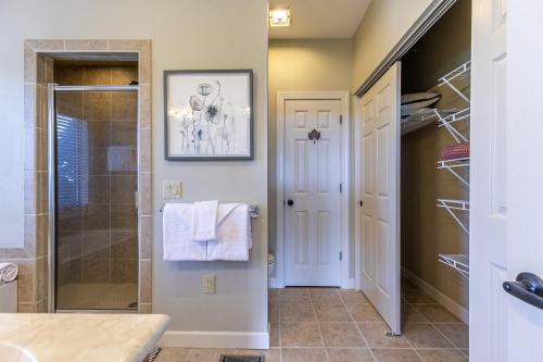 a bathroom with a walk in shower and a walk in closet at SugarJax at The Reserve in Banner Elk