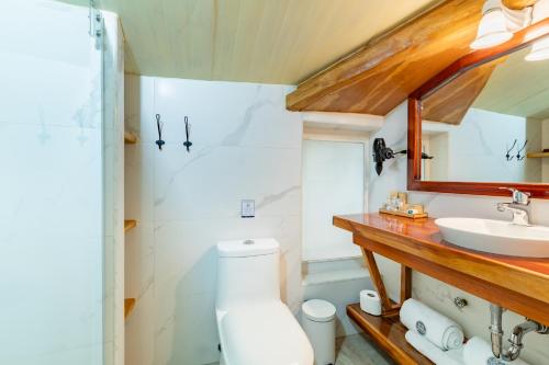 a bathroom with a toilet and a sink at Old Town Quito Suites, Heritage Hotel, Historic center in Quito