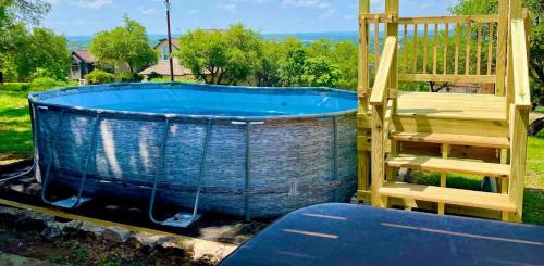 a swimming pool with a wooden deck and a blue tub at 8b 4b nearby pool Blanco wine trail town sq in Blanco