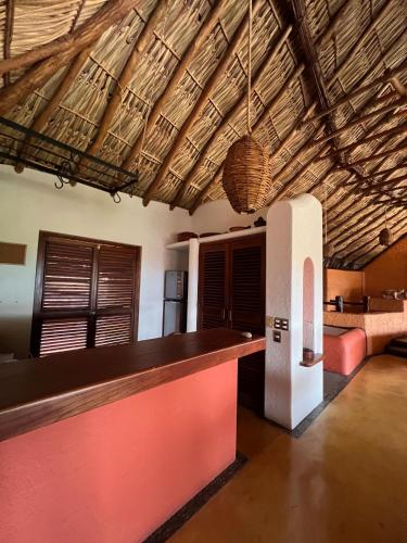 a kitchen with a bar in a room at Ensueño de Fuga in Zihuatanejo